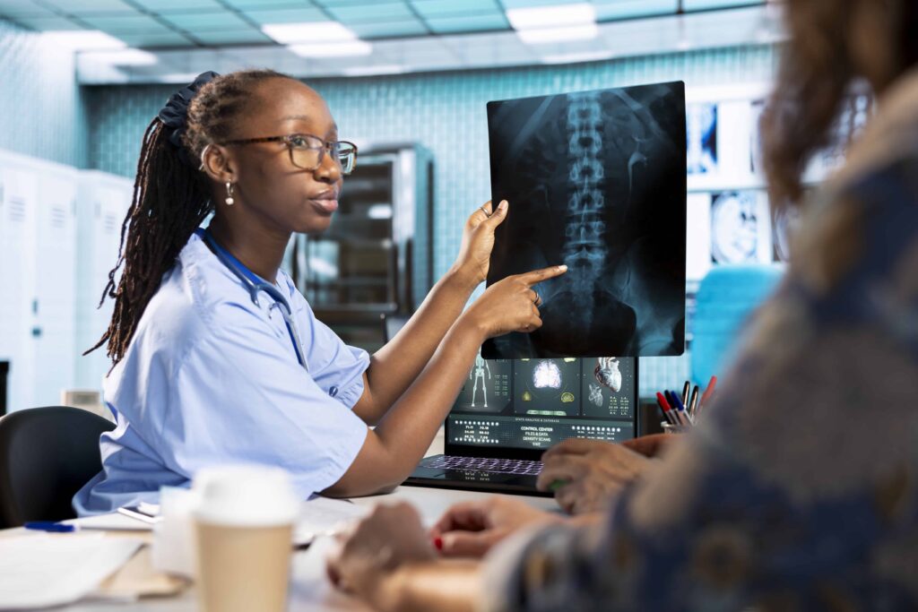 african american assistant sharing medical records information with old patient